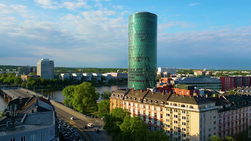 4K Aerial Drone Video of the Modern Westhafen Tower on the Banks fo the Main River in Downtown Frankfurt, Germany