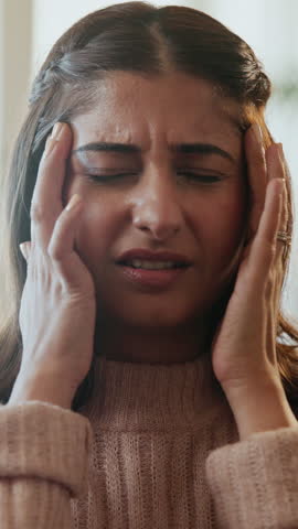 Woman, headache and frustrated with stress in home, sofa and tired with temple massage in lounge. Girl, migraine and fatigue with pain on couch, vertigo and burnout in living room at apartment