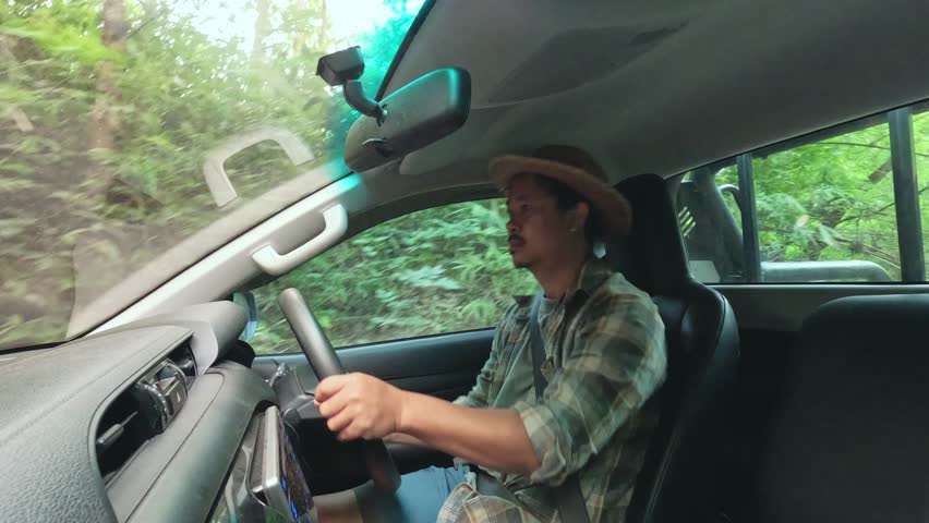 A young Asian man embarks on a thrilling off-road adventure, driving through rugged trails, muddy paths, and untouched nature. The road is wild, but his spirit is wilder. sstkTravel