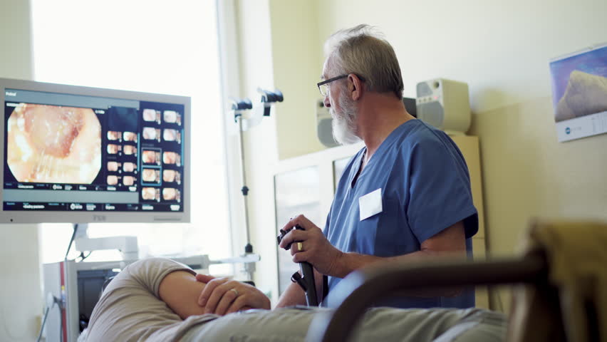 Gastroscopy procedure on sedated patient to examine upper digestive tract.