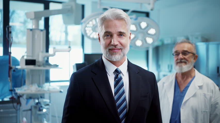 Video of pharmaceutical sales representative with doctor standing behind him.