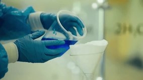 Experimenting with blue liquid and filtration in laboratory setting for scientific research purposes - Powered by Shutterstock - Get 15% off with code: PIKWIZARD15