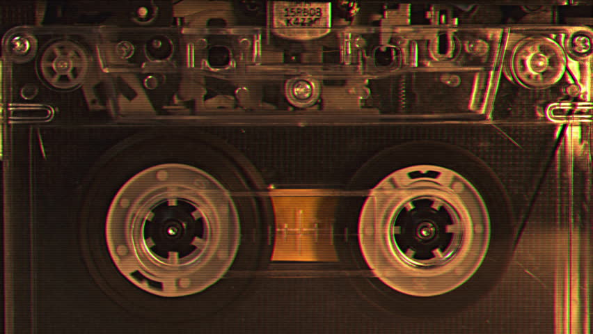 Vintage audio cassette tape recorder playing. Old school magnetic analogue reel player 1980s - 1990s. Retro style album and music technology history concept. Historical voice record FBI or CIA archive