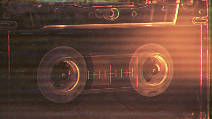 Vintage audio cassette tape recorder playing. Old school magnetic analogue reel player 1980s - 1990s. Retro style album and music technology history concept. Historical voice record FBI or CIA archive