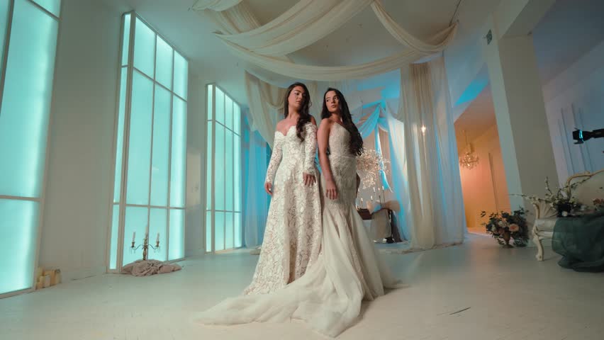 Candid shot of two beautifull female brides during their wedding ceremony indoor 
