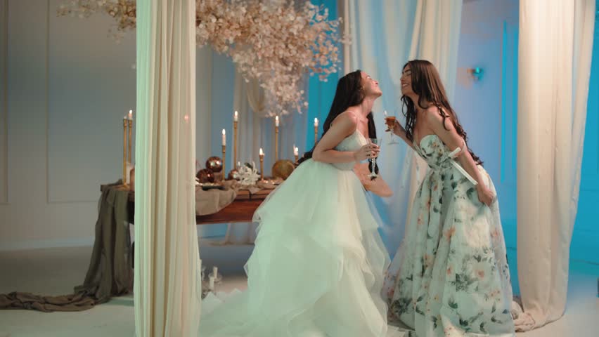 Candid shot of two beautifull female brides during their wedding ceremony indoor 