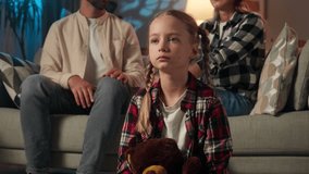 Family quarrel problem at home frustrated stressed little Caucasian girl daughter close face with hands suffering parents arguing loud on couch tired child kid unhappy mother father conflict evening - Powered by Shutterstock - Get 15% off with code: PIKWIZARD15