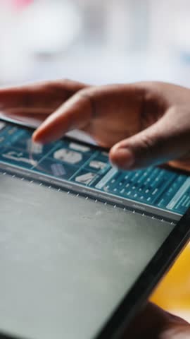 Vertical Video Black photovoltaics factory technician monitoring system performance on tablet. Solar panels manufacturing plant supervisor pleased by high production, inspecting efficiency. Camera A.