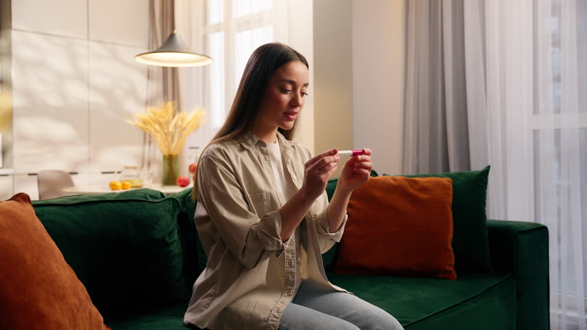 Caucasian woman excited with pregnancy test positive at home girl female happy pregnant celebrate smiling successful fertilization medicine health childbirth anticipation baby future mother family