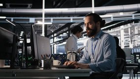 Server room IT specialist frustrated by difficult complex tasks in office. Stressed engineer developing neural network software while working extended hours in data center, camera A - Powered by Shutterstock - Get 15% off with code: PIKWIZARD15