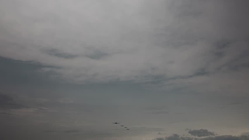 Formation flight of vintage military aircraft led by Boeing B17 Flying Fortress under dramatic cloudy sky evokes World War II nostalgia air power heritage and cinematic historical tension