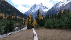 Tourists walking at Siguniangshan in autumn, Sichuan in China. - Powered by Shutterstock - Get 15% off with code: PIKWIZARD15