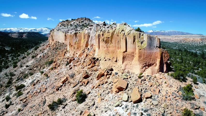Panoramic View of a Rugged, Sandstone Rock Formation under a Blue Sky