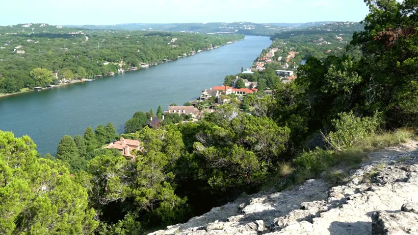 Panoramic View of Riverfront Homes and Lush Green Landscape