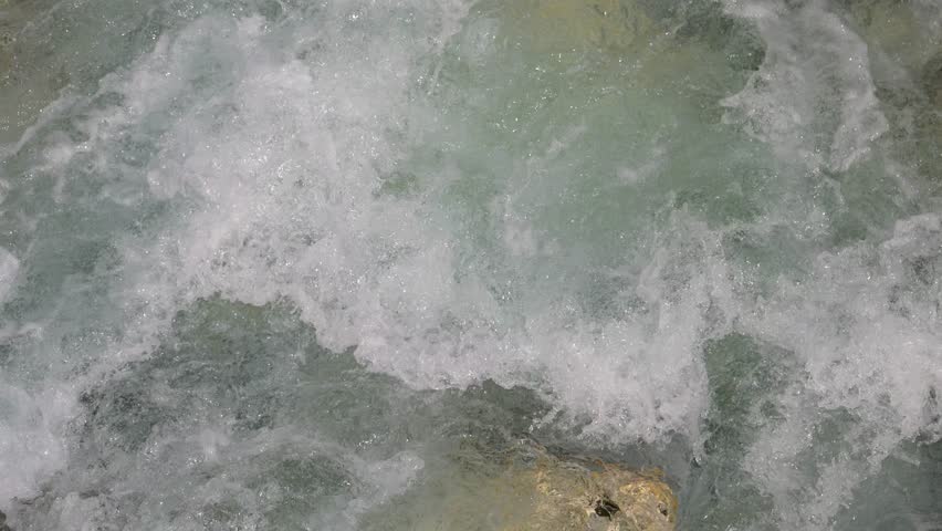 Glacier stream water flowing through the Alps