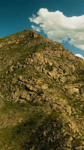 Old mountain peak under cloudy sky aerial view. Awe large rocky ridge attracts extreme climber at picturesque highland. Gorgeous hill slopes