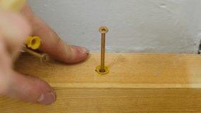 Worker hand knocks with hammer on nail head installing into wooden plank closeup. Handyman engages in renovation project preparing frame for future wall - Powered by Shutterstock - Get 15% off with code: PIKWIZARD15