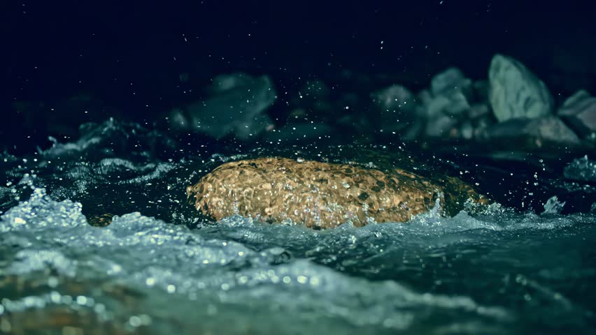 Slow motion ripple waves on dark water river.Super slow motion detail 4k video.Crystal clear spring river.Amazing dramatic night cinematic backgrounds.Epic mystical magic night view.Underwater stones