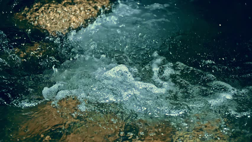 Slow motion ripple waves on dark water river.Super slow motion detail 4k video.Epic mystical magic night view.Amazing dramatic night cinematic backgrounds.Crystal clear spring river.Underwater stones