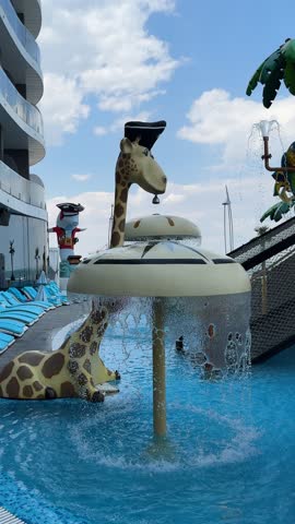 Whimsical aqua park featuring a funny giraffe in a pirate hat and a water mushroom fountain.Children