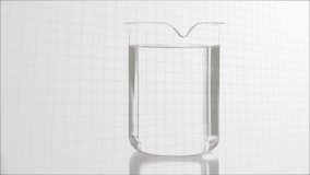 Syringe appearing injecting orange liquid into beaker, splashing color, updating virus data visuals. Laboratory, analytics, innovation, data visualization, biotech, science, experimentation - Powered by Shutterstock - Get 15% off with code: PIKWIZARD15