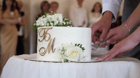 Beautiful wedding cake being cut by the bride and groom. Wedding celebration traditions. - Powered by Shutterstock - Get 15% off with code: PIKWIZARD15