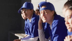 Upon baseball team settling on dugout bench, fan emojis drifting around players showing support. Athletes, teamwork, camaraderie, vibrant, youthful, outdoor, sportsmanship - Powered by Shutterstock - Get 15% off with code: PIKWIZARD15