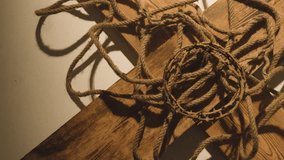 religious concept shot with crown of thorns rope and wooden cross in pool of light 1 stock video - Powered by Shutterstock - Get 15% off with code: PIKWIZARD15