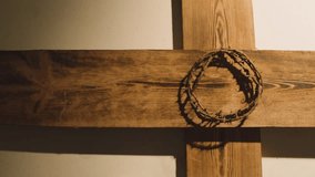 religious concept shot with crown of thorns and wooden cross in pool of light 1 stock video - Powered by Shutterstock - Get 15% off with code: PIKWIZARD15