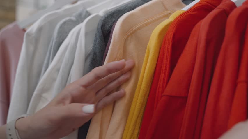 Women Browsing Clothes on a Rack