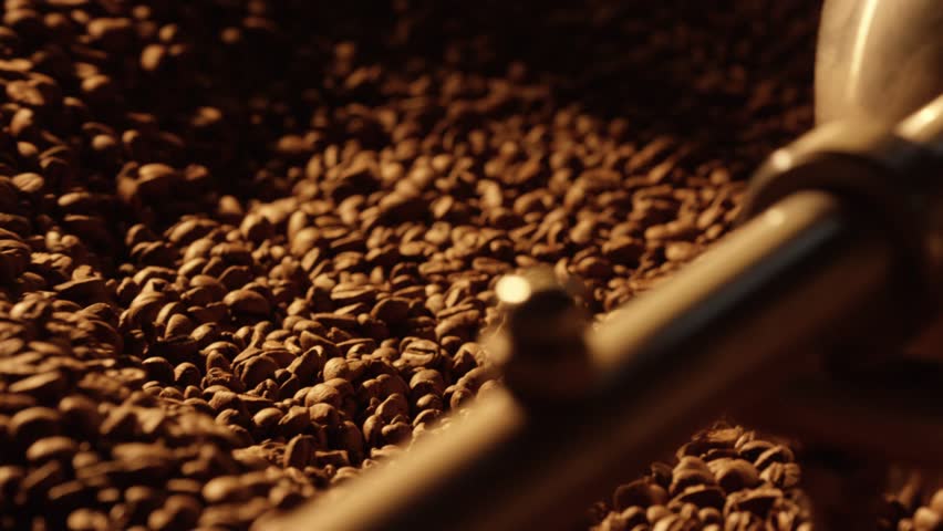 Professional coffee roasting machine illuminating warm golden light while mixing and roasting premium coffee beans, revealing intricate details of production process and seed transformation