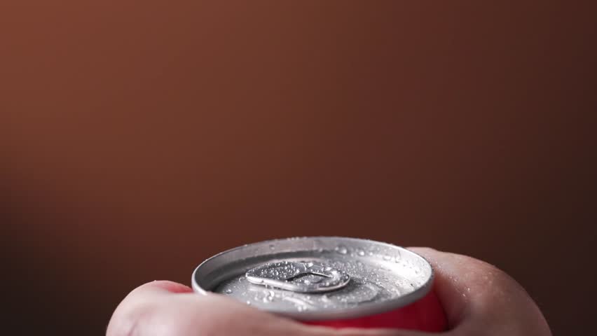 Human hand open aluminum beverage can. Drink in metal jar closeup. Opening soda can