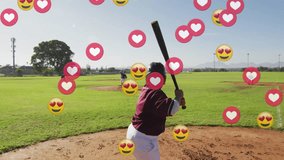 Batter gripping bat in batting stance as reaction icons floating then fading behind baseball action. Athletics, youth, teamwork, outdoor, vibrant, competition, sport - Powered by Shutterstock - Get 15% off with code: PIKWIZARD15