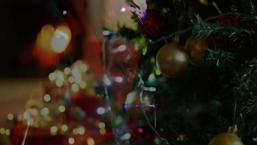 Ghostly woman appearing beside tree raising microphone and singing holiday carol under purple glow. Festive, celebration, performance, ambiance, elegance, tranquility, warmth