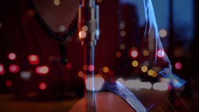 Male singer leaning in close to retro microphone, singing with drifting city bokeh in music studio. Performance, vocal, nightlife, jazz, artistry, ambiance, microphone - Powered by Shutterstock - Get 15% off with code: PIKWIZARD15