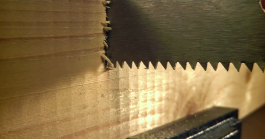 Ultra-Slow Motion Footage of Hand Saw Cutting Through Wooden Plank – Detailed Real-Time Woodworking in Carpentry and Construction Workshop