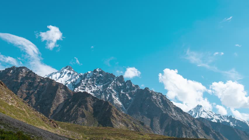 4K Timelapse of clouds moving over Himalaya mountains in Miyar valley, Himachal Pradesh, India. Summer landscape. Shadow of moving clouds over mountains. Travel background.