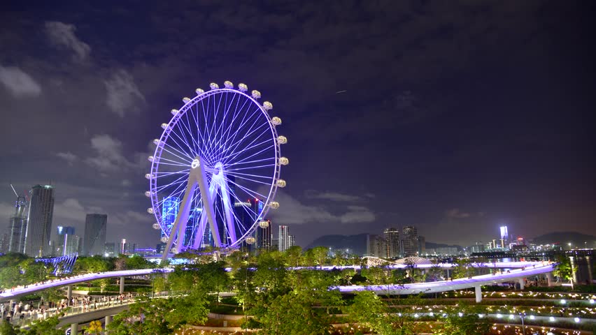 Shenzhen bay at night featuring lights and ferris wheel with park views in china
