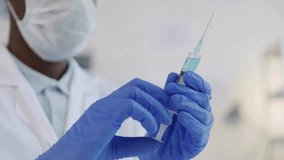 Doctor prepare syringe vaccine in protective suit disease prevention immunization Female doctor or nurse holding syringe with liquid in slow motion - Powered by Shutterstock - Get 15% off with code: PIKWIZARD15