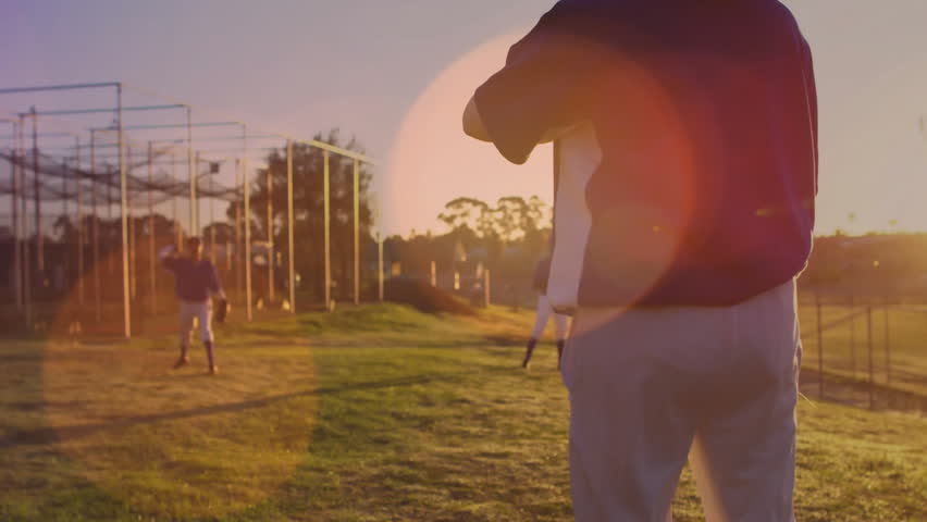Baseball pitcher winding up and tossing ball in practice with animated trajectory showing throws. Athletics, teamwork, fitness, outdoor, vibrant, competitive, endurance