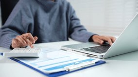 Close up of businessman working on calculator to calculate financial data report, accountancy document and laptop computer at office, business concept. - Powered by Shutterstock - Get 15% off with code: PIKWIZARD15