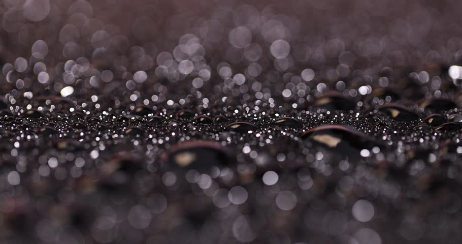 black wet glass covered with a large number of water droplets black surface