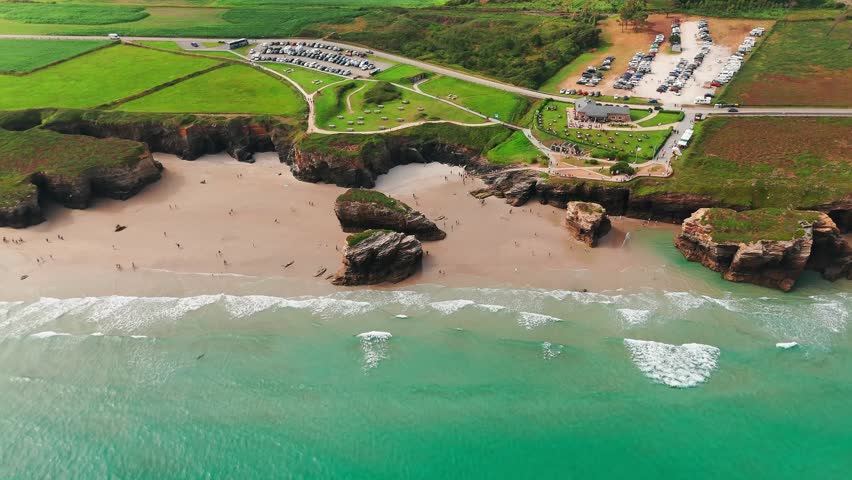 Amazing aerial view of the Playa de Las Catedrales beach in Galicia region at sunset, northern Spain. Beautiful cliff formations on famous Cathedral Beach, Cantabrian Coast 
