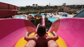 Sliding down a water park slide on a father-son vacation - Powered by Shutterstock - Get 15% off with code: PIKWIZARD15