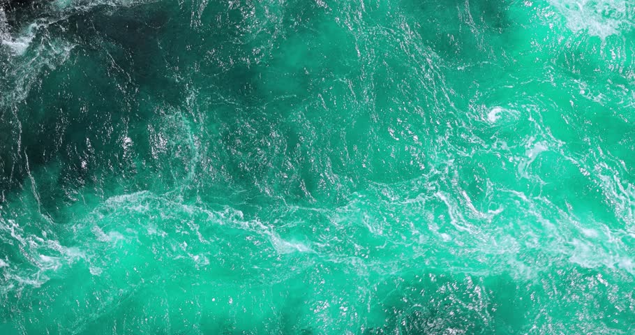 Blue waves of water of the river and the sea meet each other during high tide and low tide.