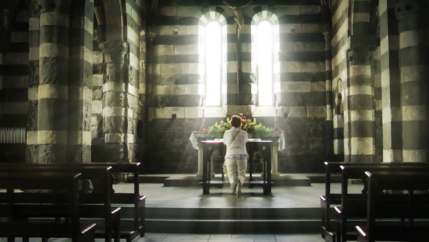 Woman praying in the Church of Saint Peter, Portovenere