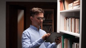 Librarian using tablet and consulting book catalog in library bookshelf - Powered by Shutterstock - Get 15% off with code: PIKWIZARD15