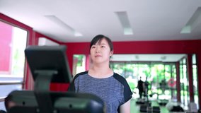 A woman running on a treadmill checks her smartwatch, which projects an augmented reality (AR) display showing real-time fitness data like heart rate, distance, and calories - Powered by Shutterstock - Get 15% off with code: PIKWIZARD15