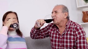 Mature couple sharing loving moment, sipping red wine with joy, relaxing together in cozy home environment during leisure time - Powered by Shutterstock - Get 15% off with code: PIKWIZARD15