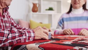 Senior couple enjoying leisurely card game, shuffling and playing together at home table with comfortable, relaxed interaction - Powered by Shutterstock - Get 15% off with code: PIKWIZARD15